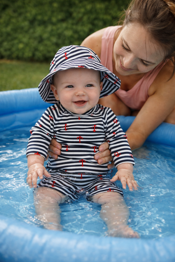 conjunto de praia menino com proteção solar listrado e com ancoras